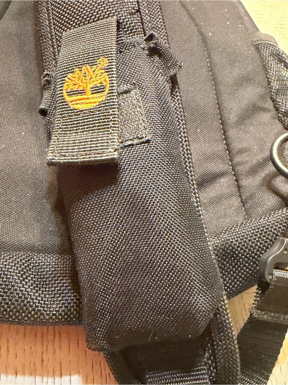 Timberland Black Sling Backpack with Brown Leather Accents
